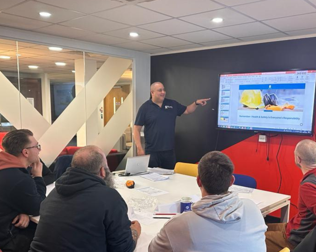 Can You Pass the CSCS Card Test Without Studying?: Instructor Sam Kerr teaching some students about safety in construction sites