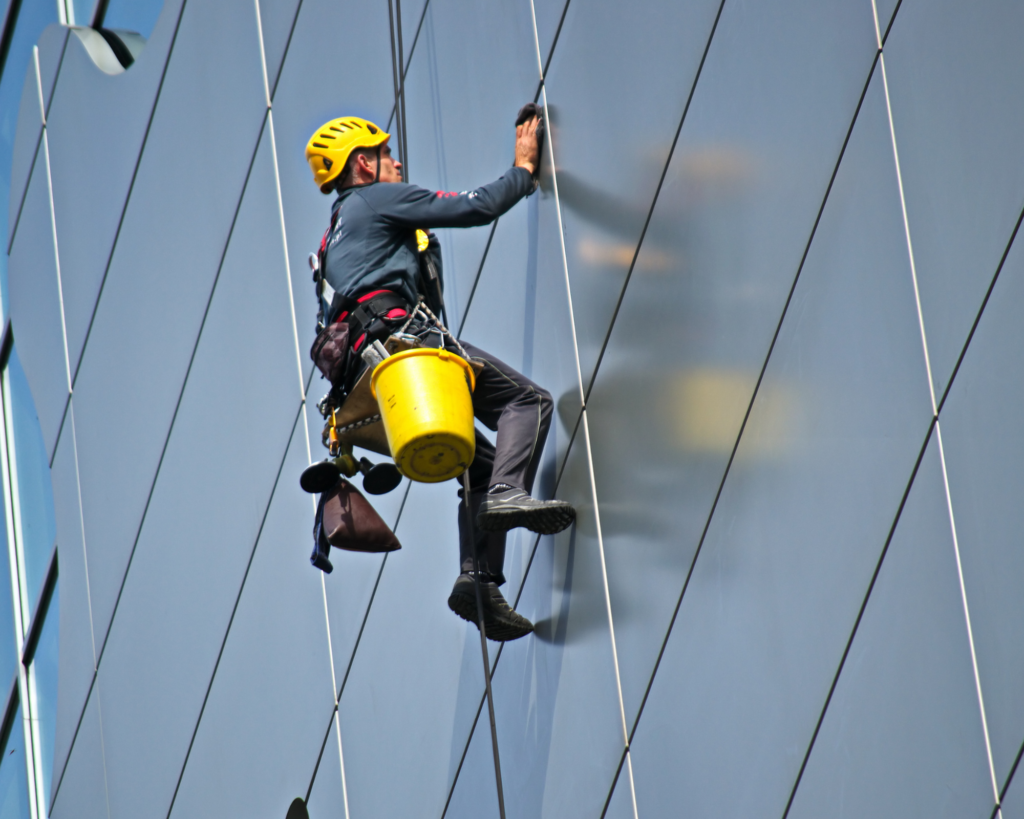 A man cleaning the surface of a wall